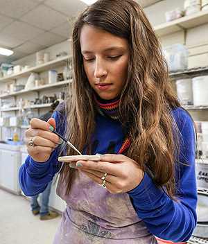 student working in pottery studio